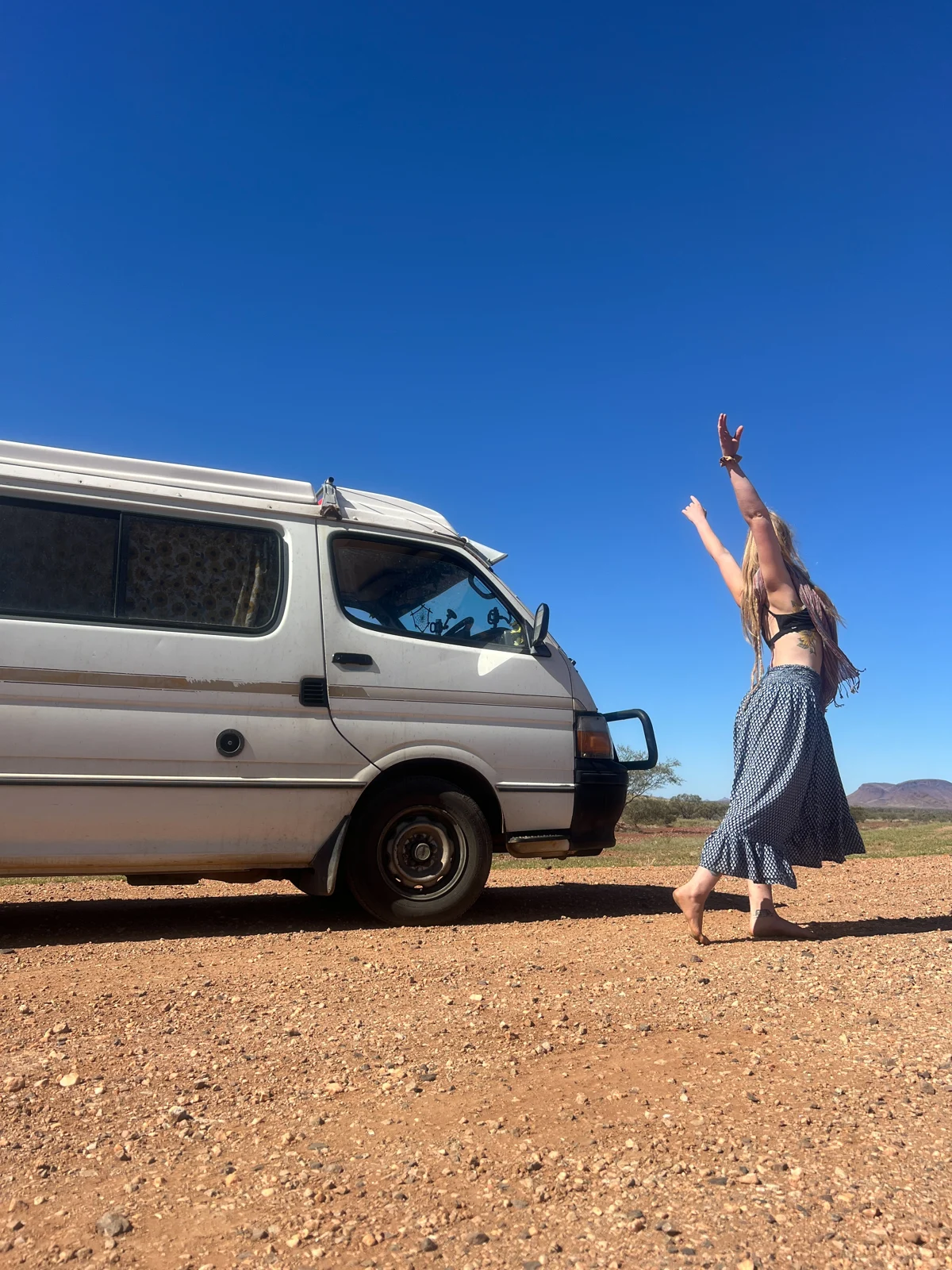 Hagar dancing beside her van in the Australian outback